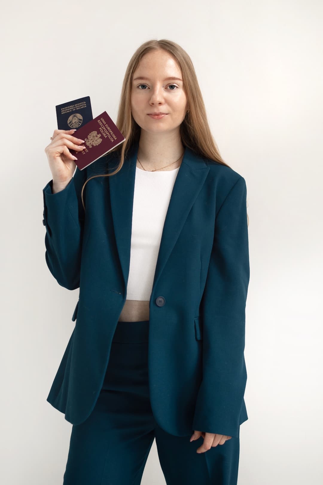 Founder holding two passports, representing immigration services