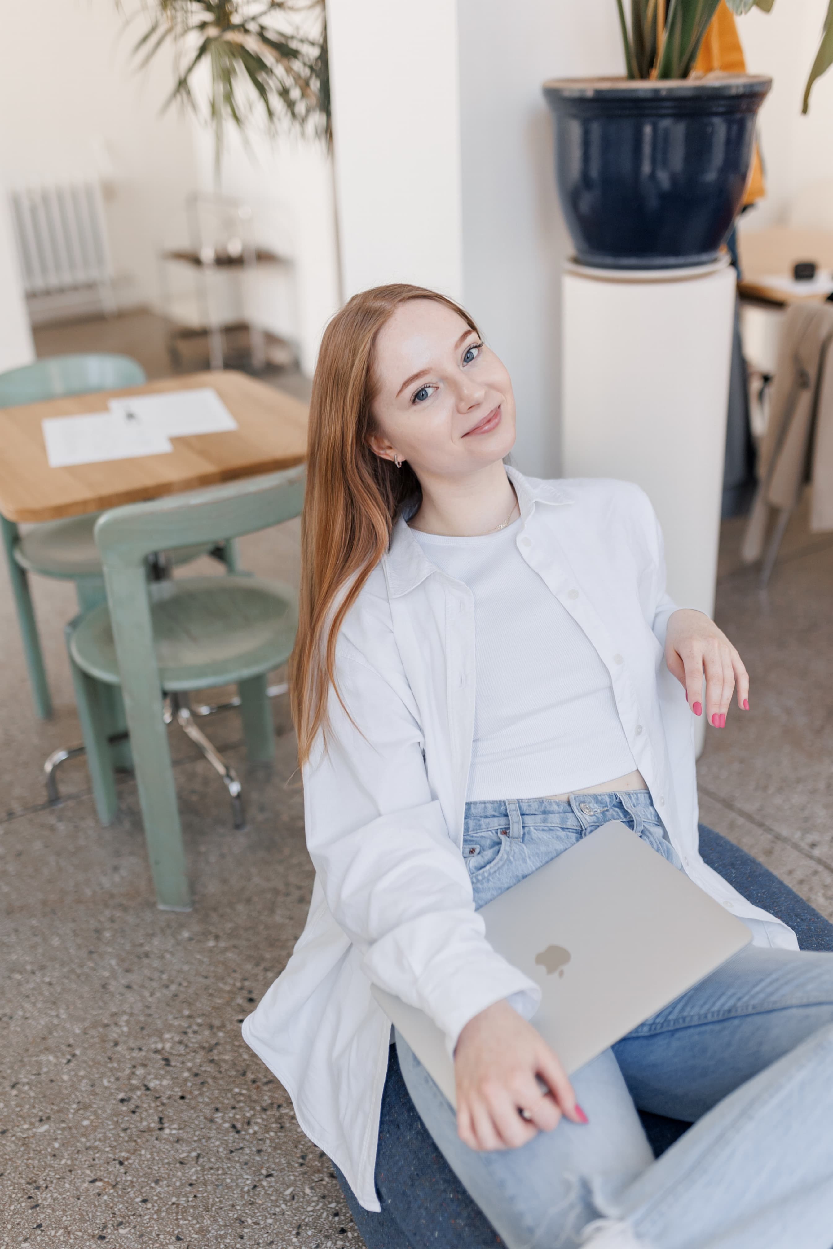 Founder smiling while sitting with a MacBook